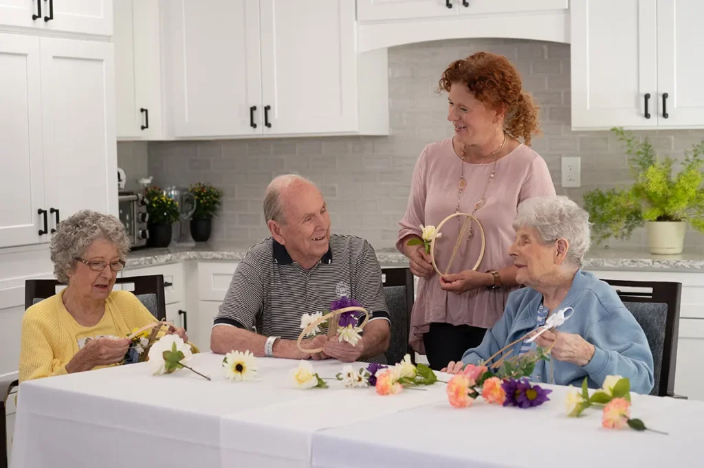 two women and a man doing a craft with a female instructor