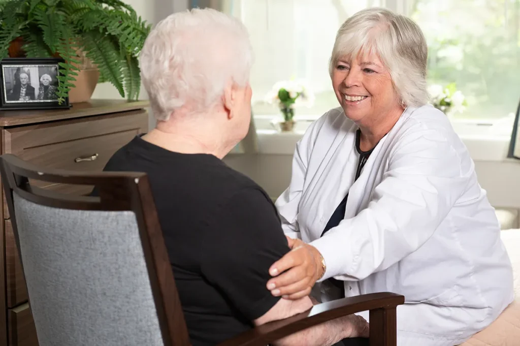 a nurse sitting with an older women