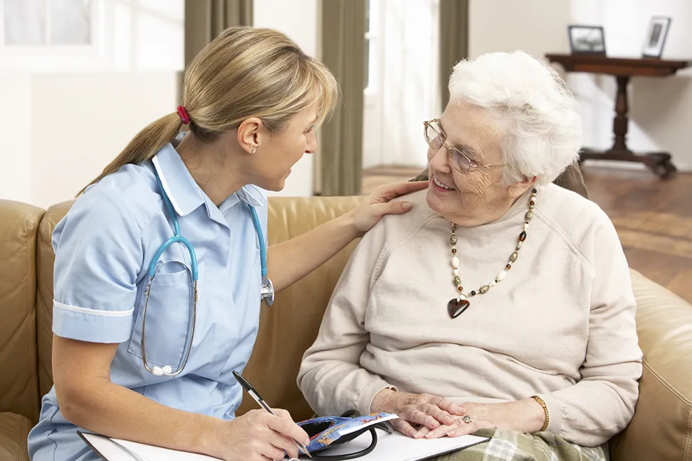 an nurse sitting with a woman