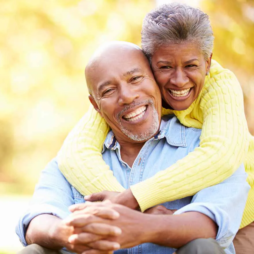 African American woman hugging her husband around the shoulders