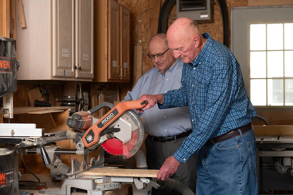 two men working in a woodshed