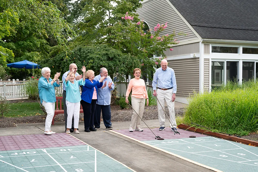 a group of men and woman playing shuffleboard